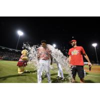 Dermis Garcia of the Charleston RiverDogs receives a bath following his game-winning hit