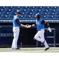 Patrick Osborn (left) congratulates Daniel Barrios on his home run during the Tampa Tarpons win