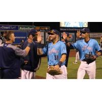 Everett AquaSox exchange high fives leaving the field after a win