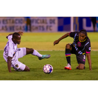 Las Vegas Lights FC defender Joel Huiqui (right) fights for possession against LA Galaxy II