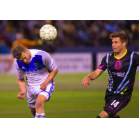 Las Vegas Lights FC midfielder Alex Mendoza (right) fights for possession against Reno 1868 FC