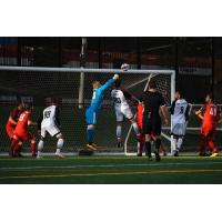 Ottawa Fury FC goalkeeper Maxime Crepeau punches a ball away from Toronto FC II