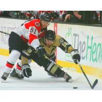 Wheeling Nailer vie for a loose puck vs. the Cincinnati Cyclones in preseason action